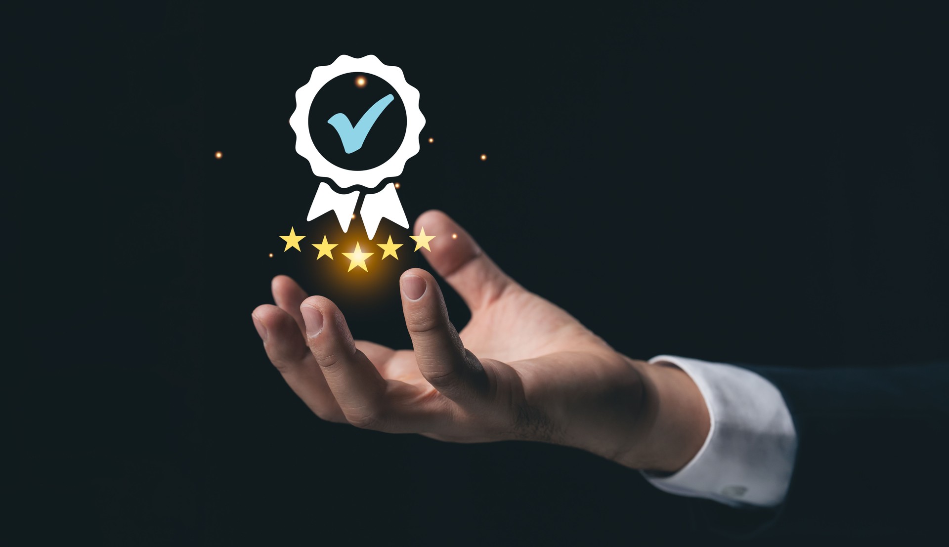 Hand Holding Badge with Stars and Checkmark Signifying Quality and Excellence in Business and Achievement Recognition on Dark Background